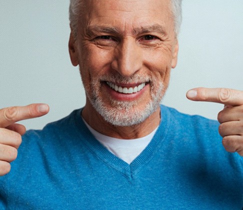 Man smiling while wearing dentures
